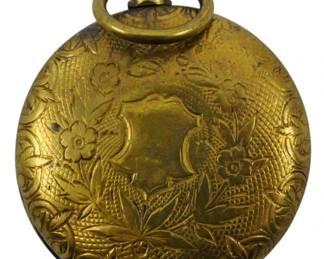68 - Victorian Mourning Locket 1" (Description): Victorian mourning locket featuring an  engraved floral design with a central  cartouche. The locket has a bail at top for  wearing on a chain. Measures 1 inch.