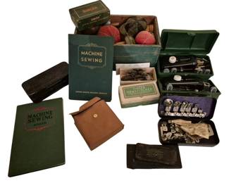 4170 - Vtg Singer Sewing Machine Accessories Lot (Description): Vintage sewing accessories group lot  featuring Singer brand items. The collection  includes Singer Machine Sewing instruction  books, Singer sewing machine attachments in  original boxes, a Singer Hemstitcher in original packaging, various presser feet and  attachments in metal cases, pin cushions, and  assorted sewing notions stored in a wooden  box. A leather pouch is also included among  the accessories.