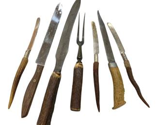 1232 - Assorted Bone Handle Knives & Etc (Description): Collection of vintage carving utensils  featuring antler and wood handles. The set  includes various knives with steel blades and  one two-pronged carving fork. Several pieces  feature decorative metal collars or ferrules between the handles and blades. The handles  display natural textures and tones ranging  from light bone to dark wood.