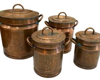 656 - Set of 4 Hammered Copper Canisters w/ Lids (Description): A set of four copper canisters with lids. The  canisters feature a hammered finish and are  graduated in size, each with side handles and  a lid handle. The largest measures 8.5  inches by 8 inches.