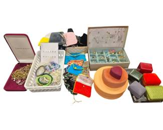 2748 - Group Vtg Jewelry, Boxes & Bags (Description): A collection of vintage jewelry, jewelry  boxes, and bags. The grouping includes  assorted costume jewelry pieces such as  bracelets, necklaces, and earrings housed in  a plastic basket. Also featured are various jewelry storage solutions including a Camrose  & Kross presentation case, a vintage  fleur-de-lis decorated jewelry box with  compartments, stackable round wooden boxes,  and assorted velvet and fabric ring boxes in