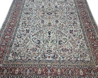 2044 - Traditional Persian Area Rug 111"x65" (Description): Featuring an ornate floral and foliate design  on a cream-colored field. The central field  is surrounded by multiple decorative borders  in rust red, navy blue, and green tones. The  rug has fringed ends.
