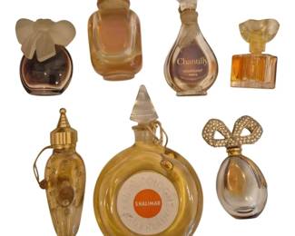1491 - Collection of Vtg Miniature Perfume Bottles (Description): A collection of vintage miniature perfume  bottles featuring various designer  fragrances. The group includes a Guerlain  Shalimar Eau de Cologne bottle with  distinctive round shape and orange label, a Houbigant Chantilly Paris bottle, and several  other decorative miniature perfume bottles  with ornate stoppers. Notable pieces include  a bottle with a frosted butterfly stopper,  one with a rhinestone bow decoration, and a