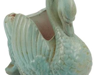 1864 - Conder Swan Planter 8" (Description): Conder swan planter with an aqua glaze  finish. The planter features detailed feather  texturing and a graceful curved neck design.  Measures 8 inches.