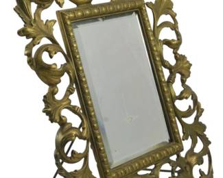 873 - Victorian Rococo Revival Mirror 11.5" (Description): Victorian Rococo Revival mirror featuring an  ornate openwork frame with scrolling acanthus  leaf motifs in cast brass. The rectangular  beveled mirror is surrounded by a beaded  inner border. Measures 11.5 inches.