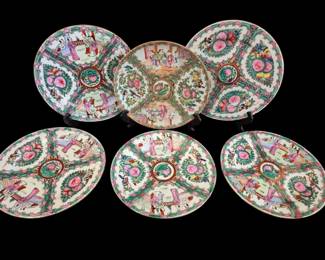 495 - 6 Rose Medallion Plates 10" (Description): Set of six Chinese Rose Medallion porcelain  plates measuring 10 inches in diameter. Each  plate features traditional hand-painted  decoration with alternating panels depicting  figural court scenes and floral motifs including pink peonies and green foliage. The  center medallions display birds and  botanical designs in the classic Rose  Medallion style with characteristic pink,  green, and gold enameled palette.