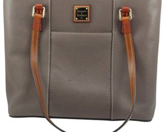 1797 - Vtg Dooney and Bourke 1975 Leather Tote Bag (Description): Vintage Dooney and Bourke 1975 leather tote  bag. This classic pebbled leather tote  features dual shoulder straps and the  signature Dooney & Bourke logo plaque.  Measures 10 inches by 12 inches by 3.5 inches.