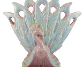 1872 - Monumental Vintage Royal Haeger Peacock Vase (Description): Vintage Royal Haeger peacock vase featuring  the bird with its tail feathers displayed in  a fan formation. The piece showcases a soft  pastel color palette. Measures 15 inches by  15 inches by 3.5 inches.