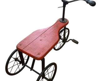 1337 - Antique Child's Tricycle 19"x22"x17" (Description): Antique child's tricycle featuring a red  painted wooden seat and black metal frame  with wire-spoke wheels.