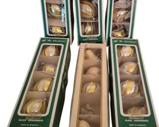 4073 - 6 Boxes Mr. Christmas Glass Ornaments (Description): Six boxes of Mr. Christmas glass ornaments,  made in Germany. The collection features gold  and silver teardrop-shaped ornaments in  their original packaging. One ornament is  missing from the set. The boxes display the classic Mr. Christmas branding with green and  white labels.