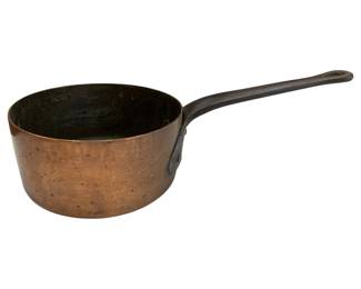 651 - Vtg Copper Saucepan w/ Iron Handle 3"x6" (Description): Vintage copper saucepan featuring a long iron  handle with a hanging hole at the end. The  pan shows a warm, aged patina consistent with  use and age. The interior appears to have a  dark finish. Measures 3 inches high by 6 inches in diameter.