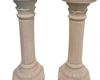 3740 - 2 Plaster Pedestals 28.5" (Description): Pair of white plaster pedestals in a  classical column style. Each pedestal  features a fluted shaft with decorative  acanthus leaf detailing at the capital, an  octagonal base with carved embellishments, and a round flat top suitable for displaying  sculpture or decorative objects. Measures  28.5 inches tall.