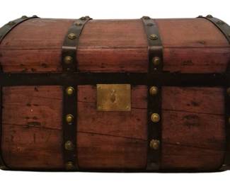 3706 - Wooden Dome Top Trunk 15"x24"x15" (Description): Antique wooden dome top trunk featuring metal  strap banding with decorative brass studs  and a brass lock plate on the front. The  trunk displays a warm reddish-brown wood  finish with visible patina consistent with age. Measures 15 inches high by 24 inches  wide by 15 inches deep.