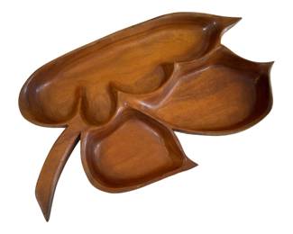 580 - Mid Century Teak Leaf Bowl 24"x15"x2" (Description): Mid Century teak leaf bowl featuring an  organic, sculptural design with three divided  sections carved from a single piece of wood.  The bowl showcases beautiful wood grain and  a warm honey-brown finish. Measures 24 inches by 15 inches by 2 inches.