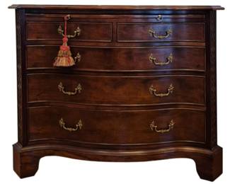 511 - Serpentine Bachelor Chest by Century, 34x42x19.5 (Description): Chippendale style serpentine front bachelor  or server chest crafted in rich mahogany.  Features two small drawers over three  graduated long drawers, all with elegant  brass bail pulls and decorative escutcheons. The piece displays characteristic Chippendale  elements including pierced fretwork corner  brackets and bracket feet with a shaped  apron. The serpentine front adds graceful  movement to the design. Measures 24 inches