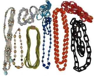 2704 - Group Mid Century Beaded Necklaces (Description): A collection of mid century beaded necklaces  featuring a variety of styles and materials.  The group includes necklaces with turquoise  and brass-toned beads, clear crystal beads,  multi-strand lime green seed beads, cobalt blue glass beads, orange glass oval beads, a  teal twisted multi-strand piece, a red and  orange braided strand, and a black plastic  chain link necklace.