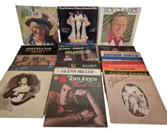 3906 - Vintage Albums, Johnny Cash & More (Description): A group of vintage vinyl LP records featuring  a variety of artists and musical genres. The  collection includes albums by John Denver,  Tony Orlando & Dawn, Roy Clark, Johnny Cash,  Jerry Lee Lewis, Harry Belafonte, Charlie Rich, Arthur Smith, Glenn Miller, Tom Jones,  The Three Suns, The Statler Brothers, and  various dance band compilations. The records  span multiple decades and represent a diverse  selection of country, pop, easy listening,