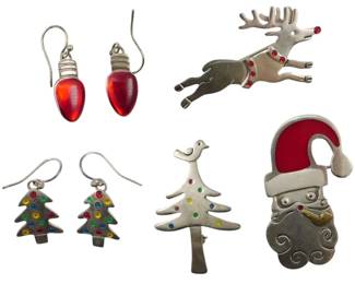 1958 - Assorted Sterling Jewelry 1.09oz (Description): Assorted sterling silver jewelry collection  weighing 1.09 ounces. The lot includes  various holiday-themed pieces featuring  Christmas motifs.