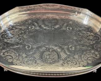 507 - Sheffield Plate Handled Tray 20"x14" (Description): Sheffield silver plate oval gallery tray  featuring an elegant pierced reticulated  gallery rim with beaded edge. The center  displays beautifully engraved scrollwork,  acanthus leaves, and floral medallions in a Victorian rococo style. The tray is fitted  with twin cutout handles for easy carrying  and rests on four decorative ball and claw  feet. Measures 20 inches by 14 inches.