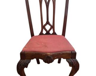 1285 - Antique Chippendale Claw Foot Side Chair (Description): A Chippendale style side chair featuring a  carved pierced splat back with scrolled crest  rail and Gothic-inspired design. The chair  has a pink upholstered slip seat and rests on  cabriole legs with carved shell knee details, terminating in ball and claw feet.  The chair is crafted in dark  mahogany-finished wood. Measures 40" x 20" x  19".