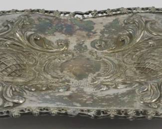 1745 - Meridan & Company Quadruple Plate Tray (Description): Meridan & Company quadruple plate tray  featuring ornate repousse decoration with  scrolling foliate designs and a decorative  pierced border. Measures 1 inch high by 6  inches wide by 7 inches long.