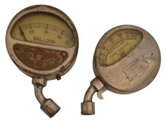2781 - Two Vtg Tire Pressure Gauges (Description): Two vintage tire pressure gauges. One is a  balloon tire gauge with a scale reading up to  50, featuring a decorative faceplate. The  other is a Yankee Tire Gauge marked "Made in  U.S.A." with a regular tire gauge scale reading up to 100. Both feature metal  construction with nickel-plated finish  showing age-appropriate patina, angled stems,  and glass-covered dial faces. Used as is electric/electronic/mechanical