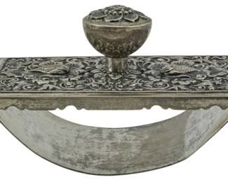 125 - Vintage .800 Silver Ink Blotter 3.5"x5"x3" (Description): Vintage .800 silver ink blotter featuring  ornate repousse decoration with scrolling  floral and bird motifs on the top surface.  The piece has a decorative knob handle and a  curved rocker base. Measures 3 1/2" x 5" x 3".
