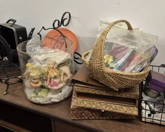 4019 - Group Lot Household & Decorative Items (Description): Group lot comprising various household and  decorative items including a black travel bar  set case with metal shot cups, a wicker  basket with handle, small figurines,  decorative boxes with snakeskin-style finish, a metal wire basket, assorted craft  supplies, and miscellaneous accessories.