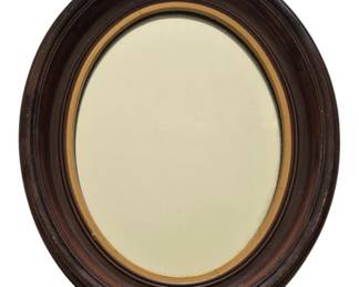 1317 - Antique Oval Wood Frame Mirror w/ Gilt Liner (Description): Dual mirror featuring an antique oval wooden  frame with a rich dark walnut finish. The  frame showcases classic molded details and is  accented with a gilt liner surrounding the  mirror glass. The piece exhibits traditional Victorian-era styling. Measures 15 inches by  12 inches.