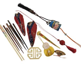 430 - Lot of Oriental Items incl Chopsticks & Decor (Description): A collection of Oriental items including  multiple pairs of chopsticks in various  materials and decorative styles, a pair of  embroidered silk lotus shoes in red and blue,  decorative tasseled ornaments with embroidered fabric elements, a carved jade or  soapstone geometric pendant, a painted  figural ornament depicting a seated figure in  yellow robes, a decorative fan-shaped piece,  and a red knotted tassel ornament. An
