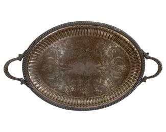 582 - Silver on Copper Serving Tray 24.5"x14.5" (Description): Silver on copper oval serving tray with  decorative handles. The tray features an  engraved scrollwork design on the interior  surface with a fluted border. Measures 24.5  inches by 14.5 inches and weighs 85 ounces.