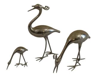 591 - 3 Chrome Metal Bird Figurines 10" (Description): Set of three chrome-plated metal bird  figurines in a modernist style, depicting  stylized wading birds with elongated legs and  necks. The tallest measures 10 inches. Sold  as-is; one beak is broken.