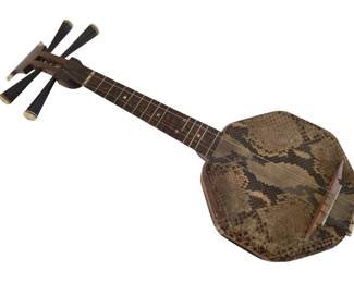 438 - Japanese Gekin 4 String Instrument 22"x8" (Description): Japanese Gekin, a traditional four-stringed  musical instrument. This example features a  distinctive octagonal body covered in  snakeskin, a dark wooden neck with frets, and  four black tuning pegs with decorative ivory-colored tips at the pegbox. The  instrument measures 22 inches by 8 inches.