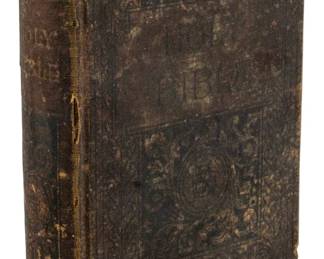 785 - 1894 Ed. The Holy Bible (Description): An 1894 edition of The Holy Bible. The volume  shows significant age and wear consistent  with its antique status, featuring a  cloth-bound cover with decorative embossed  designs.