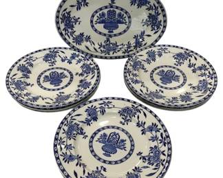 974 - Blue & White 13pc Dessert Set (Description): The set includes an oval platter and 12  multiple dinner plates, all decorated with a  central medallion depicting a flower-filled  basket surrounded by ornate floral and  foliate motifs in the traditional Delft style.