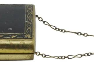 1751 - Terri Inc. N.Y. Compact w/ Lipstick Holder (Description): Vintage Terri Inc. N.Y. compact with chained  lipstick holder. The compact features a  decorative lid with an ornate border design  and blank cartouche. A chain connects the  compact to a cylindrical lipstick holder. Measures 2 1/2" x 3".
