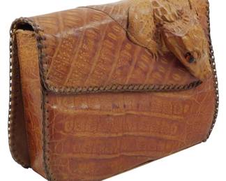 1794 - Vintage Genuine Alligator Purse 7"x8"x3.5" (Description): Vintage genuine alligator purse featuring a  full baby alligator on the flap as a  decorative element. The bag showcases natural  alligator hide with characteristic scale  patterns throughout. Measures 7 inches wide by 8 inches tall by 3.5 inches deep.