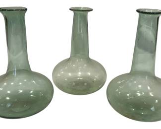 969 - Three Antique Pale Green Glass Bud Vases (Description): Three antique pale green glass bud vases with  elegant long necks and bulbous bases. The  hand-blown vessels feature a delicate  aqua-tinted glass with subtle bubbles  characteristic of early glassmaking. Each vase has a flared lip and graceful  onion-shaped body, ideal for displaying  single stems or small floral arrangements.