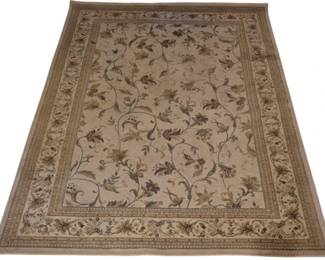 3943 - Essence Floral Area Rug 86"x59" (Description): Essence area rug featuring an elegant floral  and vine scroll pattern. The rug displays a  warm beige and tan color palette with brown  and olive green accents throughout the  botanical design. A decorative border with coordinating floral motifs frames the central  field. Measures 86 inches by 59 inches.