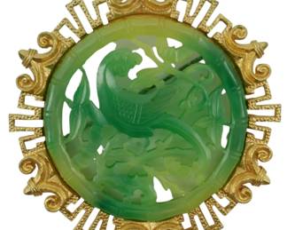 1905 - Chinese Inspired Jade or Jade Colored Pin (Description): A Chinese inspired pin featuring jade or jade  colored material. The piece showcases an  ornate design with Asian-influenced  decorative elements set in an elaborate  frame.