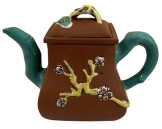 290 - Yixing Zisha Pottery Teapot w/ Bamboo 5.5"x7" (Description): Yixing Zisha pottery teapot featuring  traditional Chinese red-brown clay body with  applied enamel decoration. The teapot is  adorned with polychrome glazed pine branch  and floral motifs on the body. The spout and handle are sculpted as turquoise-glazed  bamboo branches, while the lid features a  yellow-green glazed branch-form finial with  pink floral accents. Measures 3.75 inches  high by 7 inches wide.