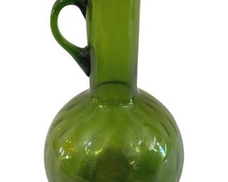 400 - Empoli Art Glass Green Pitcher 9" (Description): Empoli art glass pitcher in a vibrant green  color. This Italian glass piece features a  spherical base with an elegant elongated  neck, applied handle, and delicate pour  spout. The hand-blown glass displays the characteristic translucent quality and subtle  swirled pattern typical of mid-century  Empoli glasswork. Measures 9 inches tall.