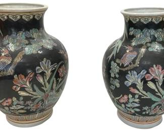 1218 - Pr Chinese Famille Noire Porcelain Vases (Description): A pair of Chinese famille noire porcelain  vases featuring a black ground with  polychrome enamel decoration. Each vase  displays birds perched on flowering branches  amid lush botanical motifs including iris, chrysanthemums, and leafy foliage. The  bulbous bodies taper to flared rims decorated  with ruyi cloud borders, while the bases  feature geometric banding. The vases showcase  the traditional famille noire palette with