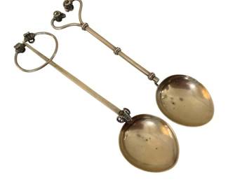379 - Salad Servers 9" long (Description): A pair of salad servers measuring 9 inches  long. The servers feature decorative handles  with ornamental finials and elongated stems  connecting to rounded bowls.
