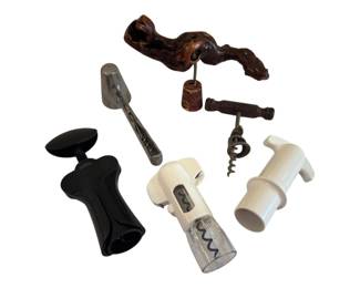 564 - Lot of Assorted Wine Corkscrews (Description): A collection of wine corkscrews featuring a  variety of styles and designs. The lot  includes a carved wooden figural corkscrew, a  traditional T-handle corkscrew with wooden  handle, a black plastic lever-style corkscrew, metal ice tongs, and two white  plastic pump-style wine openers. A useful  assortment for the wine enthusiast or barware  collector.