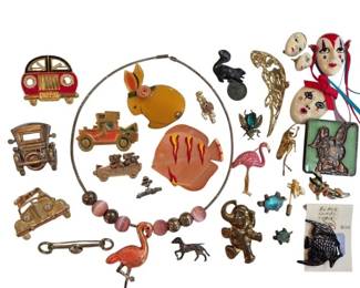 1994 - Group of Figural Costume Jewelry Brooches (Description): An eclectic collection of figural costume  jewelry brooches and pins featuring a variety  of whimsical designs. The group includes  vintage car and automobile motifs in  gold-tone metal, animal figures such as elephants, turtles, rabbits, insects, and  aflamingo with pink beads. Also included are  decorative leaf pins, a painted  bakelite-style rabbit brooch, ceramic face  ornaments with ribbons, and various other