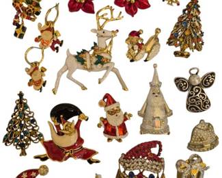1983 - Group of Christmas Jewelry Brooches & Pins (Description): A group of Christmas-themed jewelry featuring  an assortment of holiday brooches and pins.  The collection includes various festive  motifs such as Christmas trees with colorful  rhinestone ornaments, Santa Claus figures, reindeer, angels, poinsettia flowers, bells,  and gift boxes. The pieces display a variety  of finishes including gold-tone, silver-tone,  and enamel work in traditional holiday  colors of red, green, and gold. Many pieces
