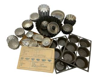 670 - Vintage Baking Items (Description): A collection of vintage baking items  including various tart molds, tartlet tins,  and muffin pans in assorted shapes and sizes.  The lot features both aluminum and tin  pieces in fluted, scalloped, and round designs, suitable for making individual  pastries.