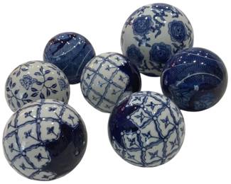 973 - Group of Blue & White Decorative Balls (Description): A collection of seven blue and white ceramic  decorative balls featuring various  hand-painted patterns. The designs include  florals, geometric lattice work, and leaf  motifs in the classic blue and white chinoiserie style.