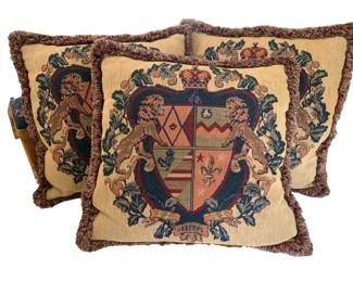 1349 - Set of 3 Heraldic Tapestry Pillows 19"x19" (Description): Set of three decorative pillows featuring a  heraldic coat of arms tapestry design with  lions, crown, and the motto "Veritas." Each  pillow is finished with fringe trim edging.  Measures 19" x 19".